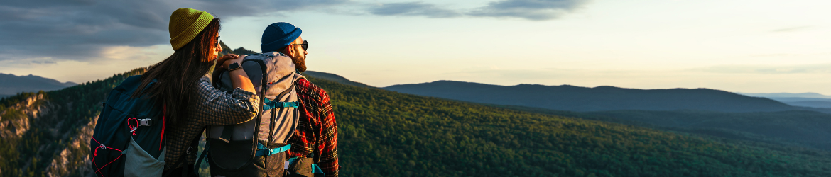 Couple sitting on mountain top.