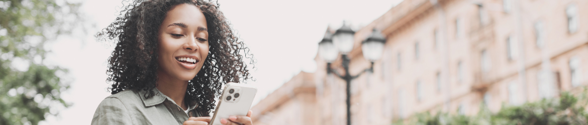 Woman using iphone in the city.