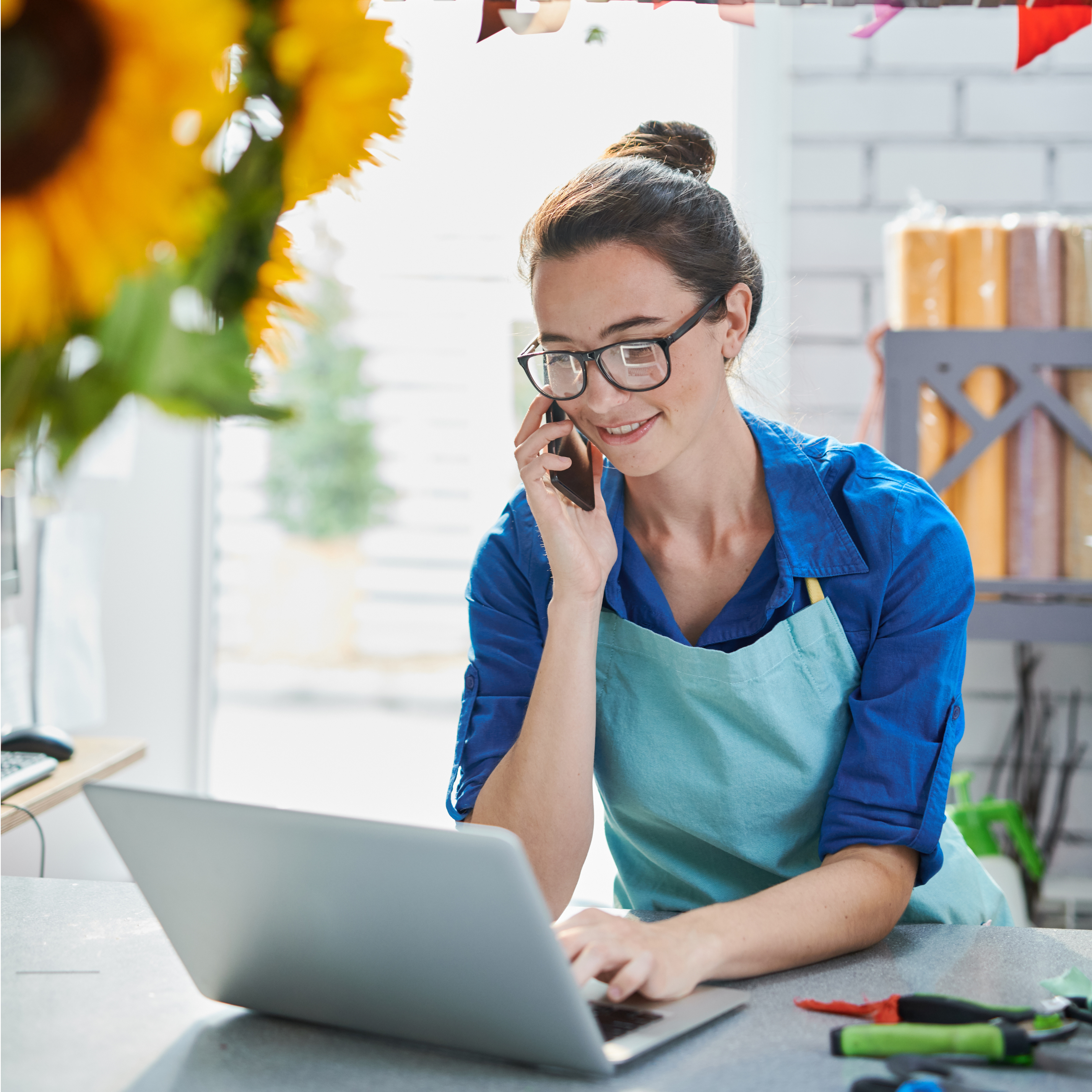 Business woman on phone and computer.