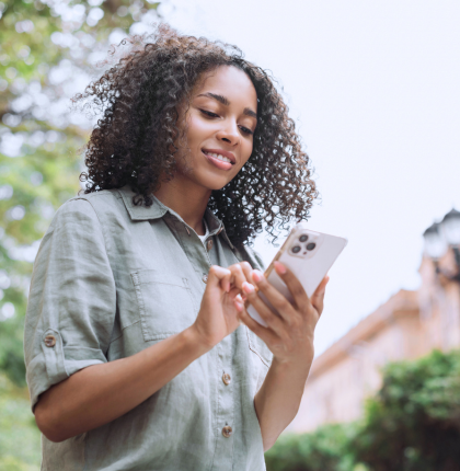 Woman using iphone in the city.