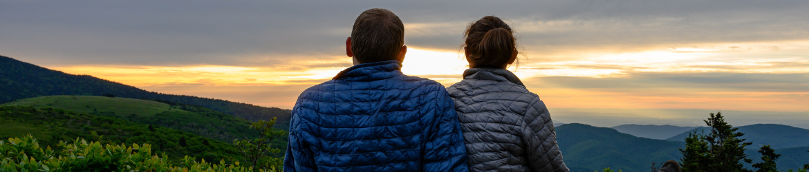 Couple overlooking sunset in Blue Ridge Mountains.